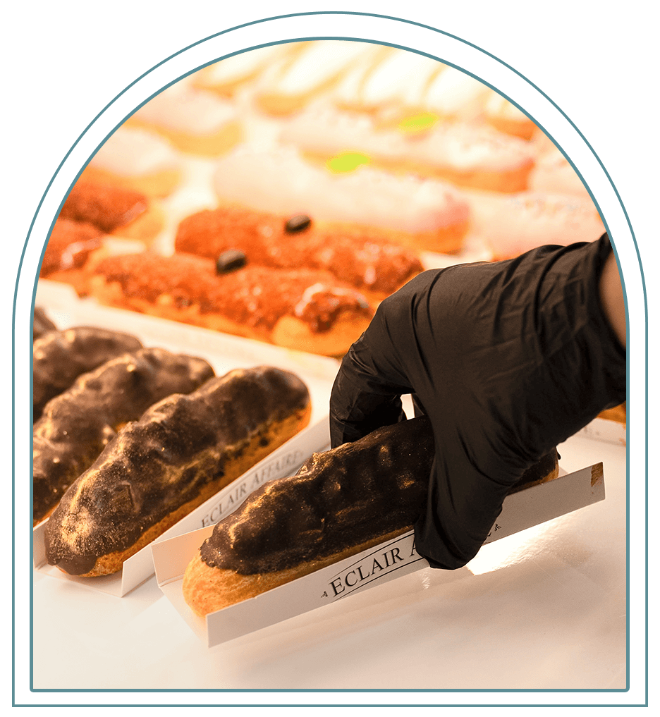 Baker presenting a handcrafted French éclair